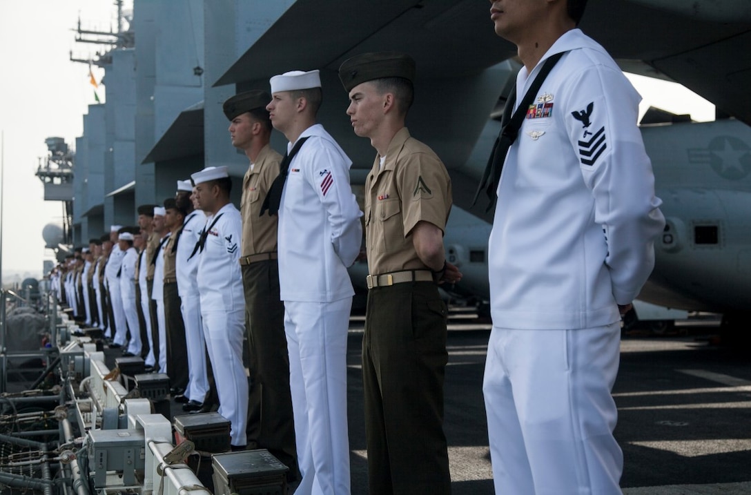U.S. Marines and Sailors with the 15th Marine Expeditionary Unit and the Essex Amphibious Ready Group man the rails aboard the USS Essex (LHD 2) as they depart San Diego, May 11, 2015, for a seven-month deployment. (U.S. Marine Corps photo by Cpl. Elize McKelvey/Released)