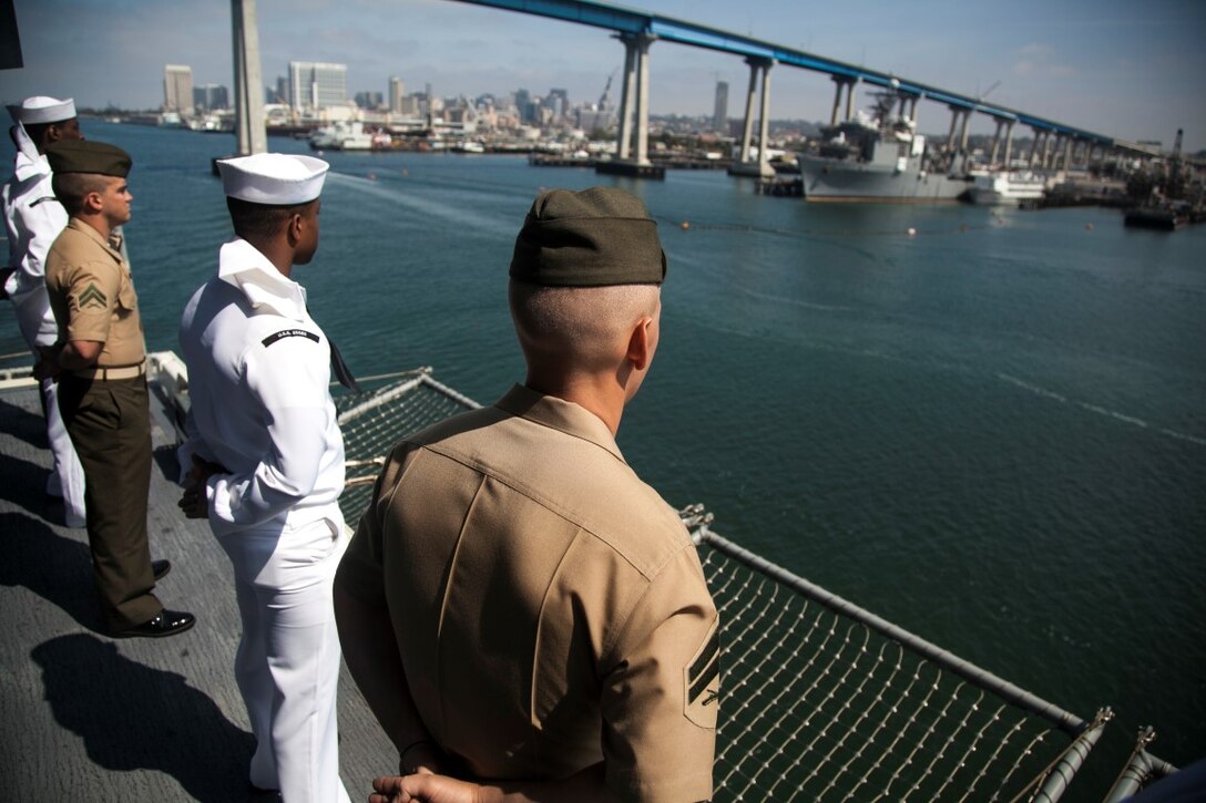 U.S. Marines and Sailors with the 15th Marine Expeditionary Unit and the Essex Amphibious Ready Group man the rails aboard the USS Essex (LHD 2) as they depart San Diego, May 11, 2015 for a seven-month deployment. (U.S. Marine Corps photo by Cpl. Elize McKelvey/Released)