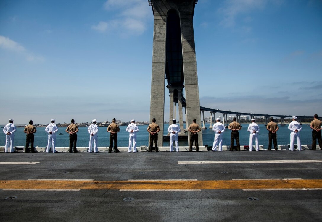 U.S. Marines and Sailors with the 15th Marine Expeditionary Unit and the Essex Amphibious Ready Group man the rails aboard the USS Essex (LHD 2) as they depart San Diego, May 11, 2015, for a seven-month deployment. (U.S. Marine Corps photo by Cpl. Elize McKelvey/Released)