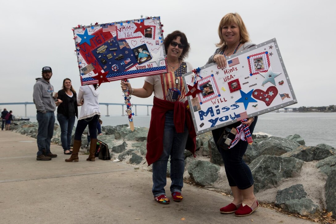 A woman displays a handmade signs for her son, a Marine crew chief with 15th Marine Expeditionary Unit, I Marine Expeditionary Force, at Embarcadero Park in San Diego, May 11, 2015. The family members of more than 4,500 Marines and Sailors gathered to watch ships depart the San Diego Harbor for a deployment in support of the Navy’s maritime strategy.