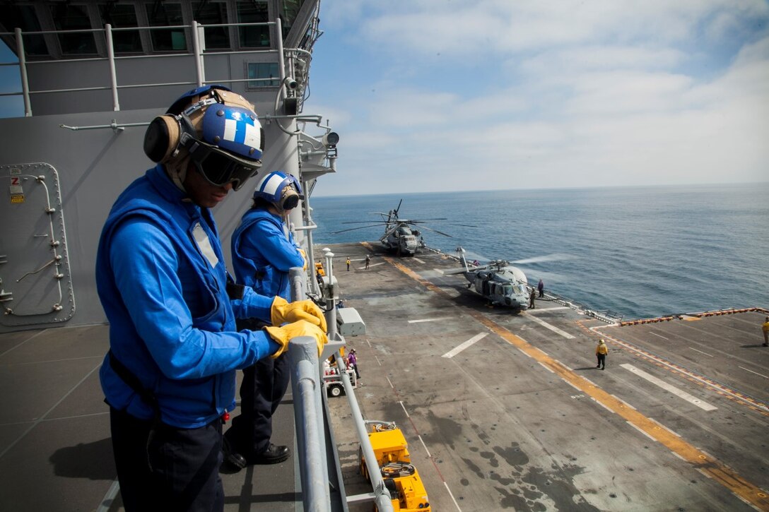 U.S. Navy Sailors with the Essex Amphibious Ready Group, observe flight deck operations aboard the USS Essex (LHD 2) off the coast of San Diego, May 11, 2015. The Marines and Sailors of the 15th Marine Expeditionary Unit and ESSEX ARG were departing for a seven-month deployment. (U.S. Marine Corps photo by Cpl. Elize McKelvey/Released)