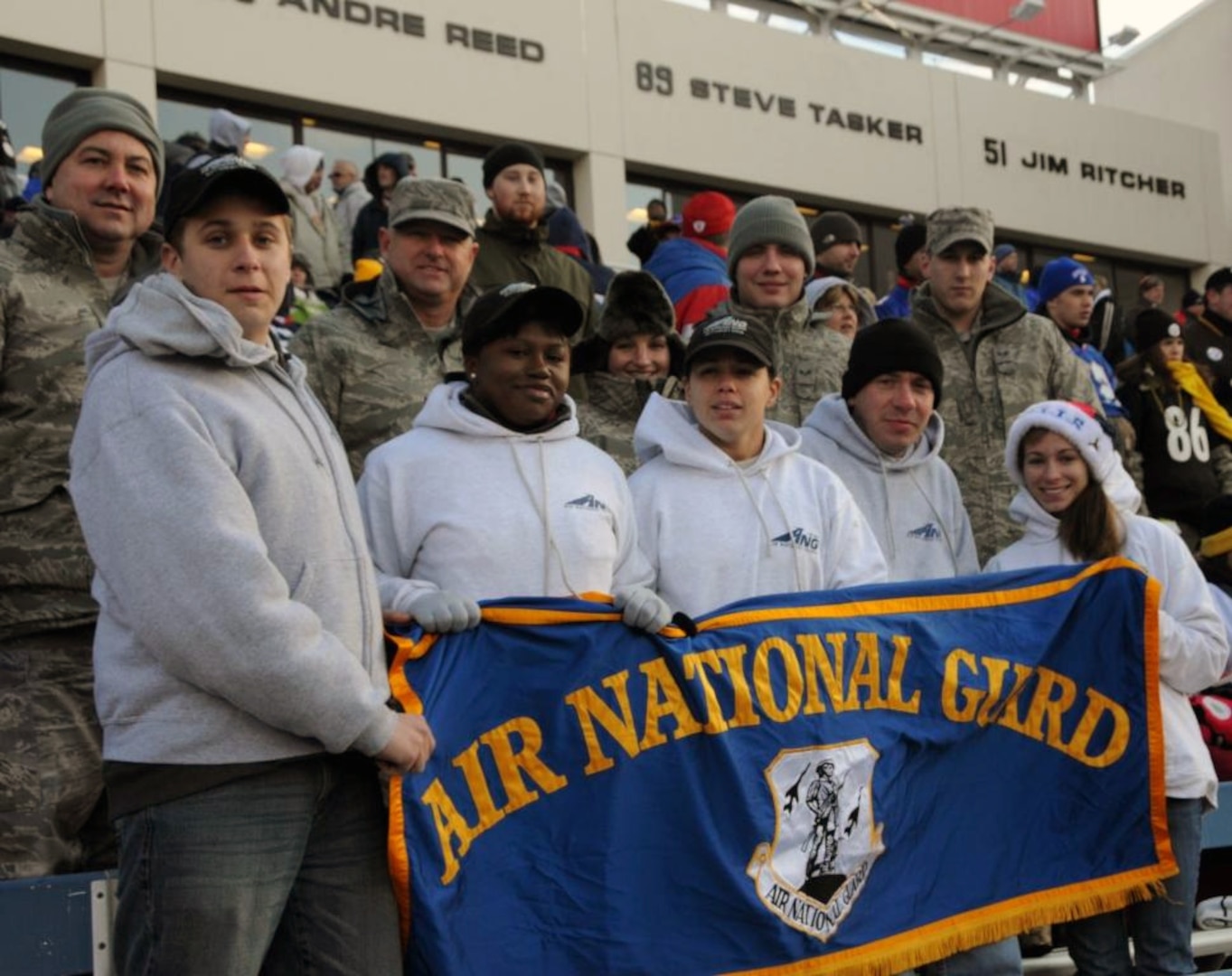 New enlistees in the New York Air National Guard's 107th Airlift Wing enjoy the Buffalo Bills game from the front row after participating in a mid-field enlistment ceremony prior to the game on Nov. 28, 2010. After the ceremony, the enlistees were joined by existing unit members to cheer on the Bills. Front row left to right are: Airmen 1st Class Daniel Treblett, Christina Swanson, Cara Sturdivant and Joanna Vail, and back row left to right, Tech. Sgt. Patrick Paolini, Staff Sgt. Peter Dean, Tech. Sgt. Charity Edwards, Senior Airmen Robert Kurzdorfer and Paul Boser.