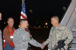 Maj. Gen. Mick Bednarek, commanding general of First Army Division East, welcomes home Lt. Col. Bobby Roach, executive officer for the Florida National Guard's 53rd Infantry Brigade Combat Team as he gets off the plane at Hunter Army Airfield, Ga.