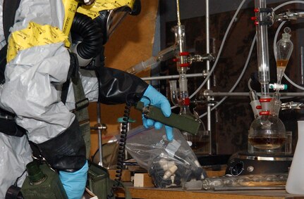 A member of the 24th Civil Support Team from the New York National Guard takes an air sample in a simulated clandistine weapons lab during the unit's validation exercise on June 8, 2010.