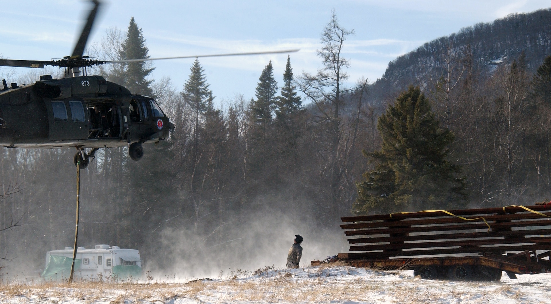 A UH-60 Blackhawk helicopter from Army Aviation Support Facility 3 based in Latham, N.Y., prepars to airlift pre-constructed platforms for the New York Department of Environmental Conservation (DEC) on Nov. 29 at this remote area of the Adirondack Mountains. The airlifted platforms will allow the DEC to eventually construct a helipad as well as a repeater radio station on top of the mountain that will be used by the DEC and other state agencies. Each platform weighed more than 2,000 pounds and were constructed in Colorado and flatbed delivered to the Adirondacks. 