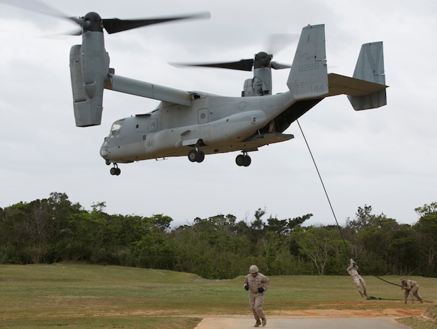 In this photo file, Marines execute helicopter rope suspension techniques out of an MV-22B Osprey tiltrotor aircraft March 12 during training at Camp Schwab, Okinawa. With these techniques, commonly referred to as fast-roping, Marines can execute tactical insertions and extractions where rotary aircraft landings are impractical, according to Marine Corps Reference Publication 3-11.4A. The Marines are with Force Reconnaissance Company, 3rd Reconnaissance Battalion, 3rd Marine Division, III Marine Expeditionary Force.
