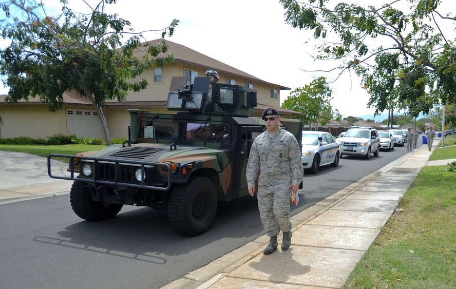 647th Security Forces Squadron Defenders took to the streets of Earhart Village for their Police on Patrol Parade through Hickam Communities to kick off Police Week May 11, 2015, at Joint Base Pearl Harbor-Hickam, Hawaii. In 1962 President Kennedy declared May 15 as National Peace Officers’ Memorial Day and the calendar week in which May 15 falls as National Police Week. Since then, Police Week has served as a time to pay special recognition to law enforcement officers who lost their lives in the line of duty for the safety and protection of others. (U.S. Air Force photo by Tech. Sgt. Terri Paden)