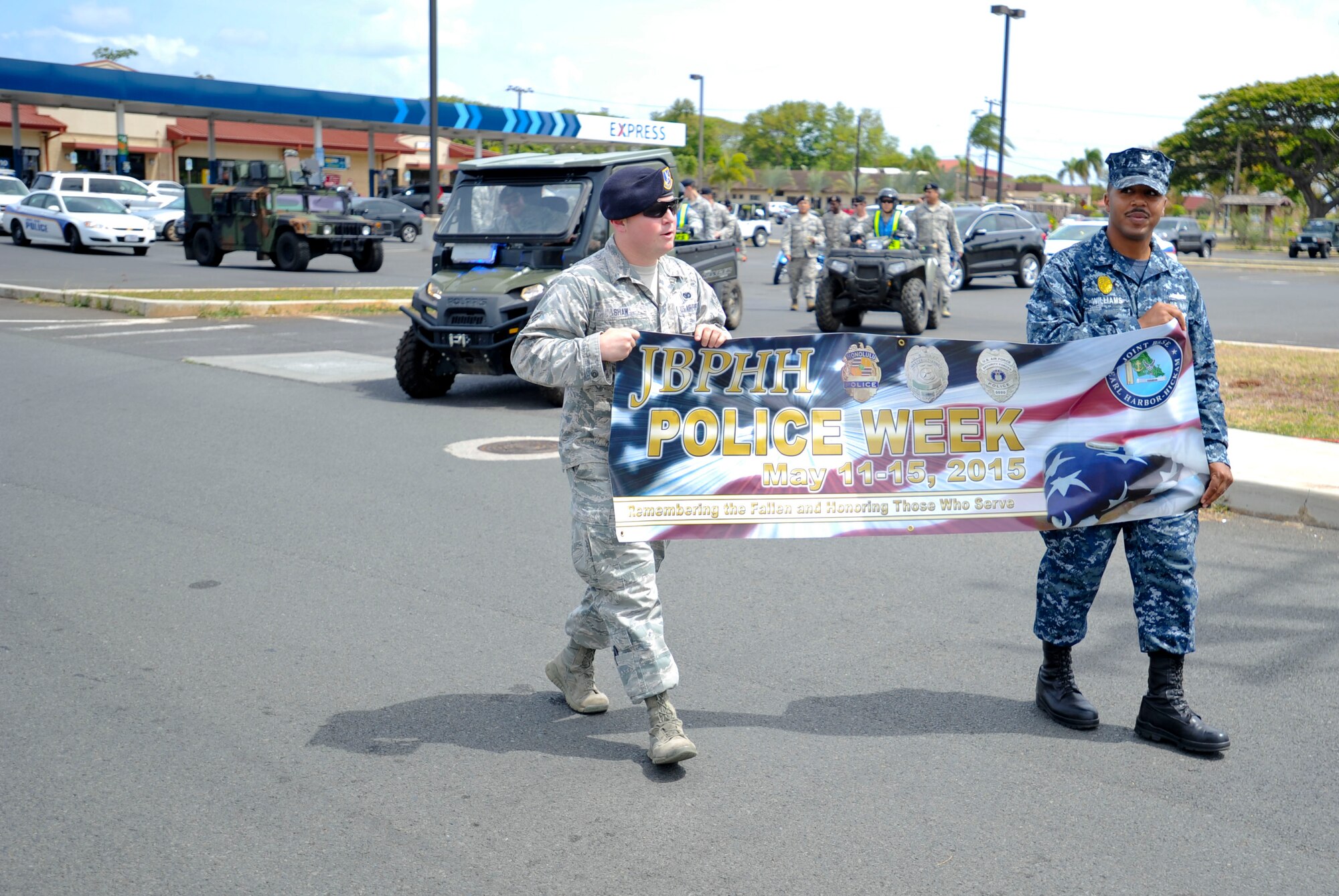 647th Security Forces Squadron Airmen and Sailor Defenders began their Police on Patrol Parade at the shoppette before making their way through Hickam Communities to kick off Police Week May 11, 2015, at Joint Base Pearl Harbor-Hickam, Hawaii. In 1962 President Kennedy declared May 15 as National Peace Officers’ Memorial Day and the calendar week in which May 15 falls as National Police Week. Since then, Police Week has served as a time to pay special recognition to law enforcement officers who lost their lives in the line of duty for the safety and protection of others. (U.S. Air Force photo by Tech. Sgt. Terri Paden)