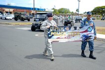 647th Security Forces Squadron Airmen and Sailor Defenders began their Police on Patrol Parade at the shoppette before making their way through Hickam Communities to kick off Police Week May 11, 2015, at Joint Base Pearl Harbor-Hickam, Hawaii. In 1962 President Kennedy declared May 15 as National Peace Officers’ Memorial Day and the calendar week in which May 15 falls as National Police Week. Since then, Police Week has served as a time to pay special recognition to law enforcement officers who lost their lives in the line of duty for the safety and protection of others. (U.S. Air Force photo by Tech. Sgt. Terri Paden)