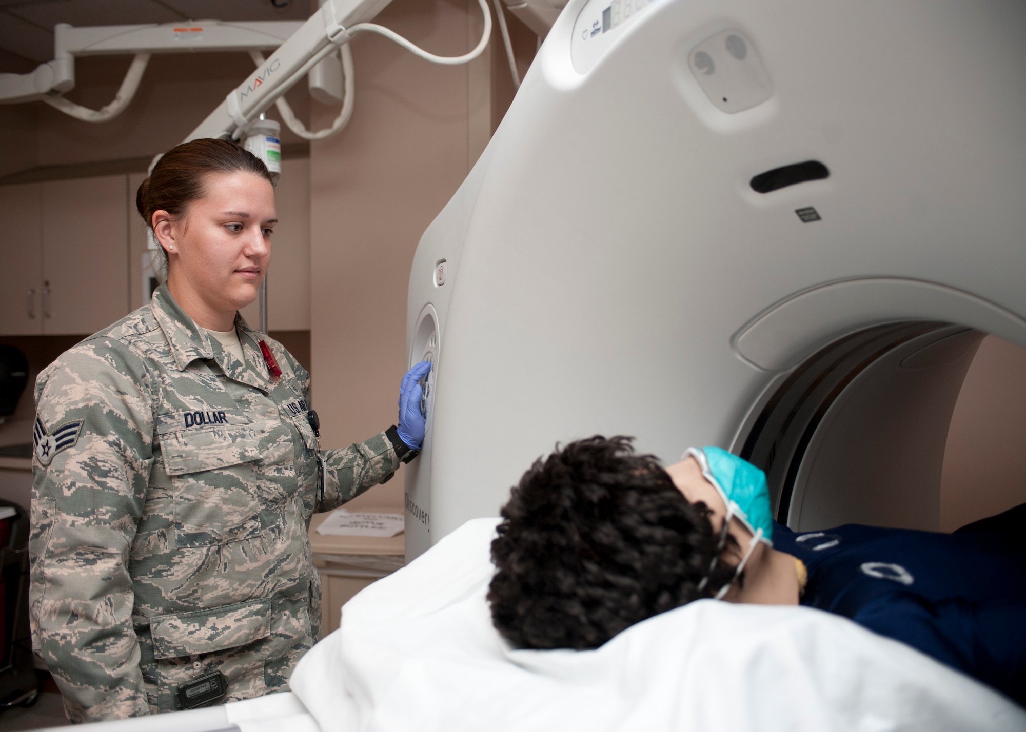 Senior Airman Alyssa Dollar, 99th Medical Surgical Operations Squadron computed tomography technician, scans a practice dummy as part of a CT scan at Nellis Air Force Base, Nev., May 1, 2015. The Diagnostic Imaging Clinic is divided into seven sections to quickly and efficiently find out what’s happening in a patient’s body. (U.S. Air Force photo by Airman 1st Class Jake Carter)