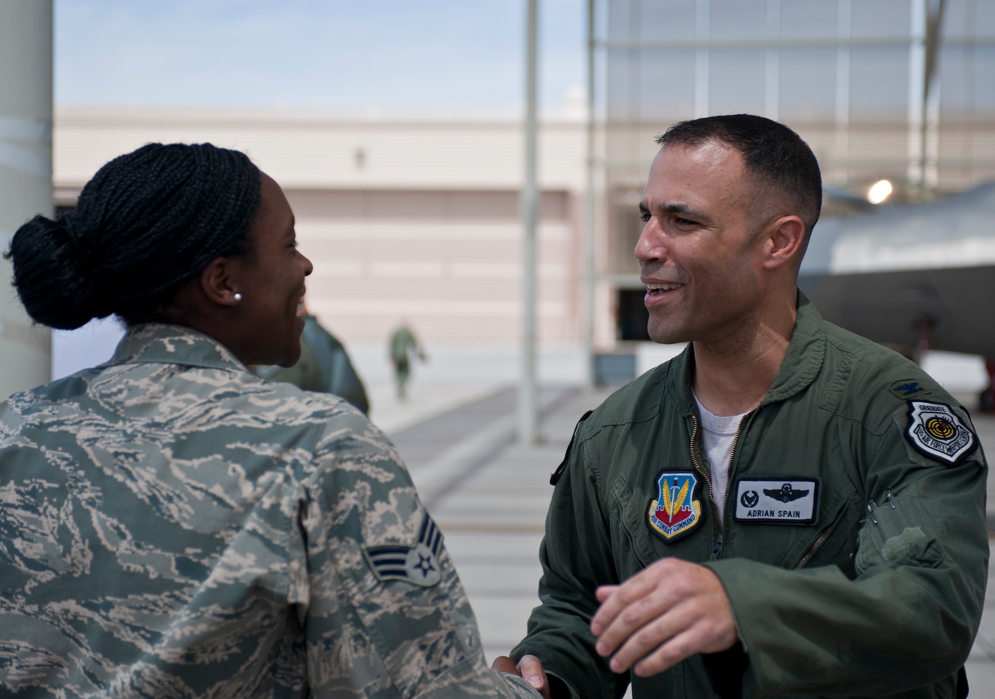 Col. Adrian Spain, U.S. Air Force Weapons School commandant, greets an Airman after his final flight as the USAFWS commandant at Nellis Air Force Base, Nev., May 11, 2015. Following his flight, Airmen from the USAFWS thanked Spain for the job he’s done serving as their commandant. (U.S. Air Force photo by Staff Sgt. Siuta B. Ika)