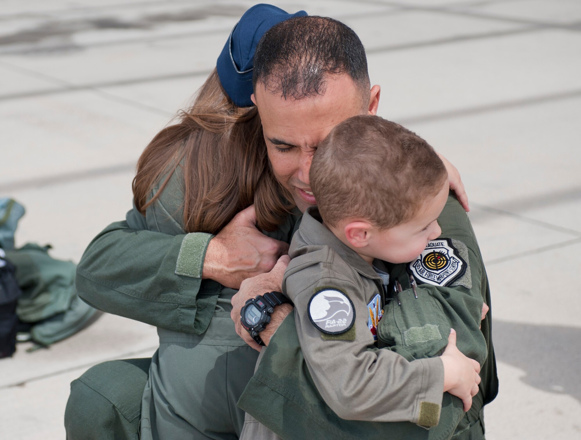 Col. Adrian Spain, U.S. Air Force Weapons School commandant, hugs his children after his final flight as the USAFWS commandant at Nellis Air Force Base, Nev., May 11, 2015. The event marked the first time Spain’s children were able to see their dad fly an aircraft. (U.S. Air Force photo by Airman 1st Class Mikaley Towle)