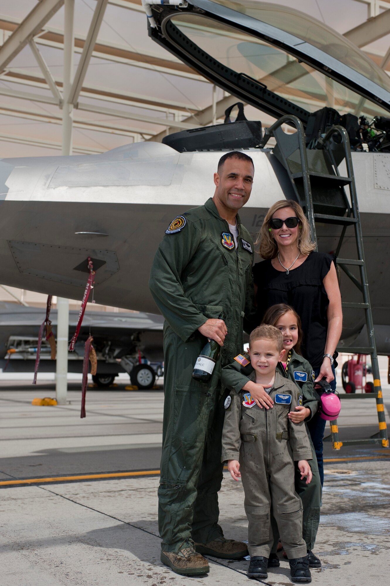 Col. Adrian Spain, U.S. Air Force Weapons School commandant, poses for a picture with his family after his final flight as the USAFWS commandant at Nellis Air Force Base, Nev., May 11, 2015. Spain’s final flight commemorated his time at Nellis AFB. (U.S. Air Force photo by Airman 1st Class Mikaley Towle)