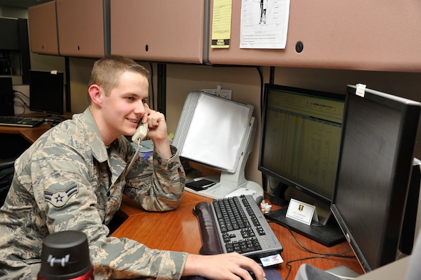 U.S. Air Force Airman 1st Class Patrick Larmann, 35th Comptroller Squadron budget analyst, responds to a phone call at Misawa Air Base, Japan, May 12, 2015. While at his workstation, Larmann answers requests for processing payment in addition to maintaining the finance office’s reimbursement system. (U.S. Air Force photo by Senior Airman Patrick S. Ciccarone/Released)