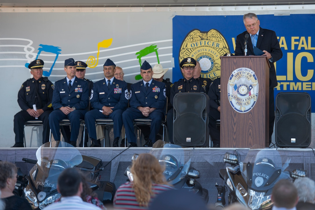 Wichita Falls, Texas, Mayor Glenn Barham, reads a proclamation for Police Week at a ceremony outside the Wichita Falls police department, May 11, 2015. The ceremony paid tribute to police officers who lost their lives in the line of duty. Sheppard Air Force Base, Texas, leadership and 82nd Training Wing Security Forces members partnered with the local police and sheriff departments during this ceremony to show their support. (U.S. Air Force photo by Senior Airman Kyle Gese/Released)