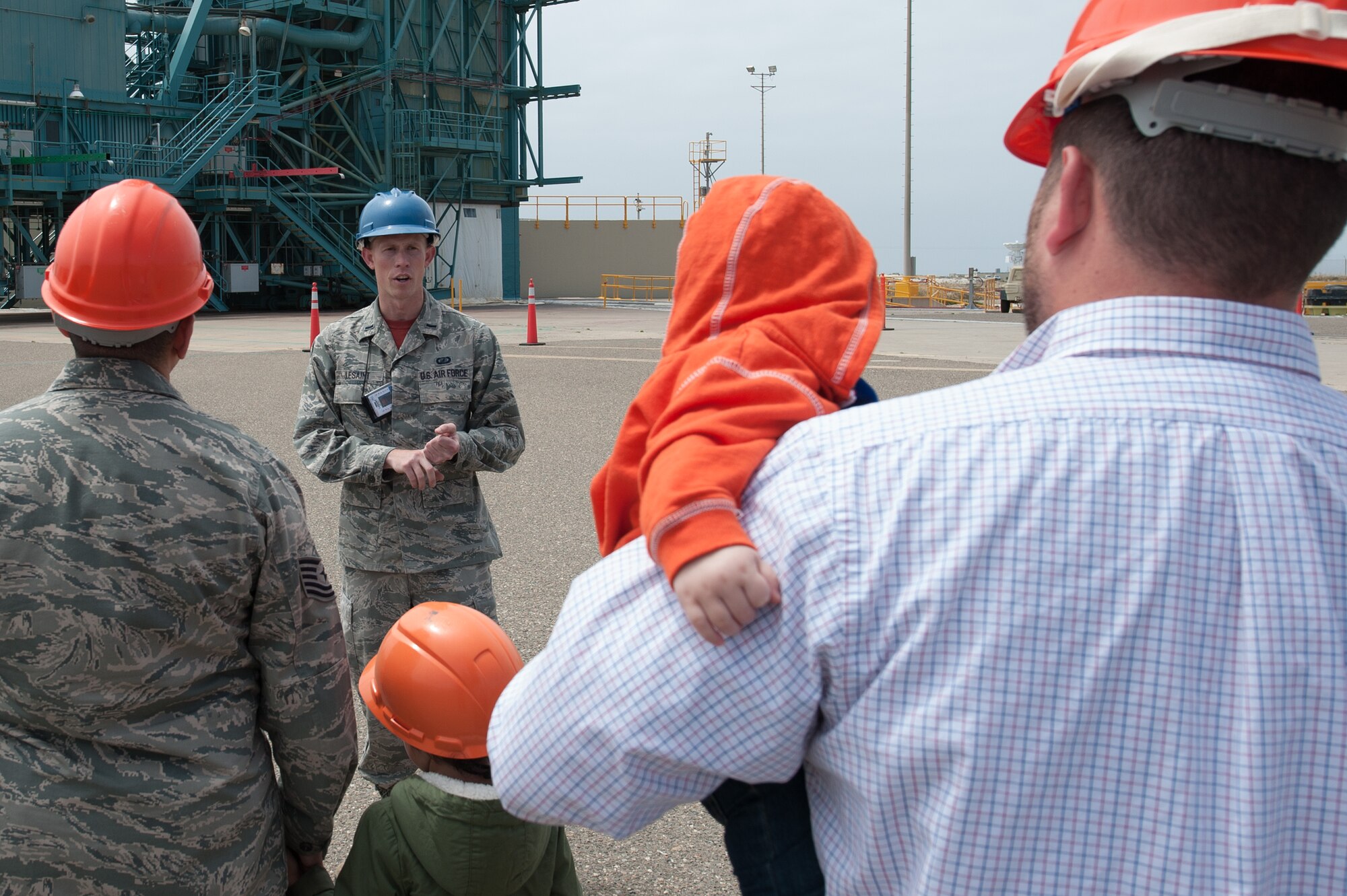 1st Lt. Matthew LeSaint, 4th Space Launch Squadron deputy chief engineer, educates Team V members and their families on the 30th Launch Group mission during the “Space Walk” tour of Space Launch Complex 2, May 8, 2015, Vandenberg Air Force Base, Calif. (U.S. Air Force Photo by Michael Peterson/Released)