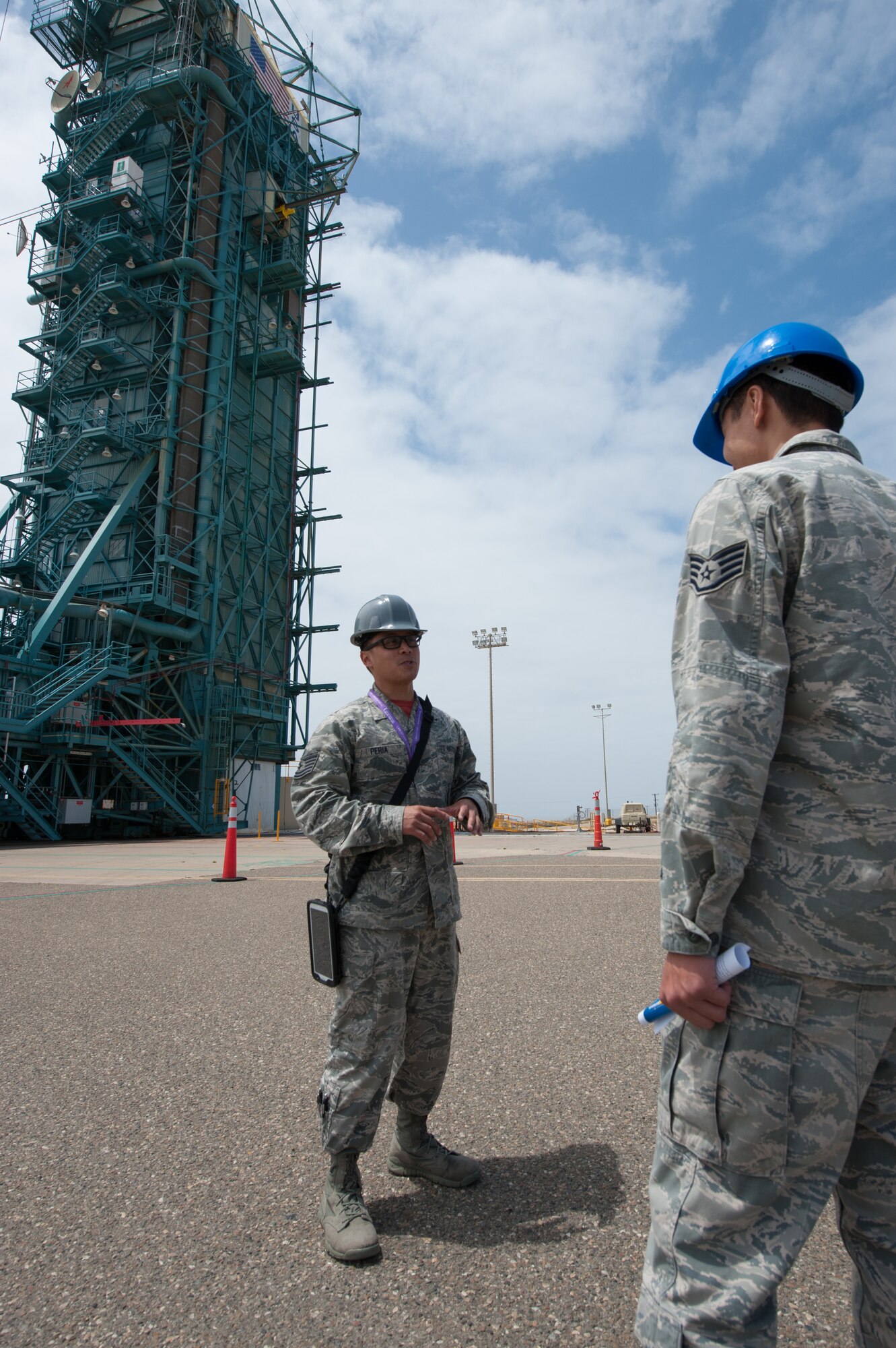 Tech. Sgt. Gerald Peria, 4th Space Launch Squadron mission assurance technician, educates Team V members and their families on the 30th Launch Group mission during the “Space Walk” tour of Space Launch Complex 2, May 8, 2015, Vandenberg Air Force Base, Calif. (U.S. Air Force Photo by Michael Peterson/Released)