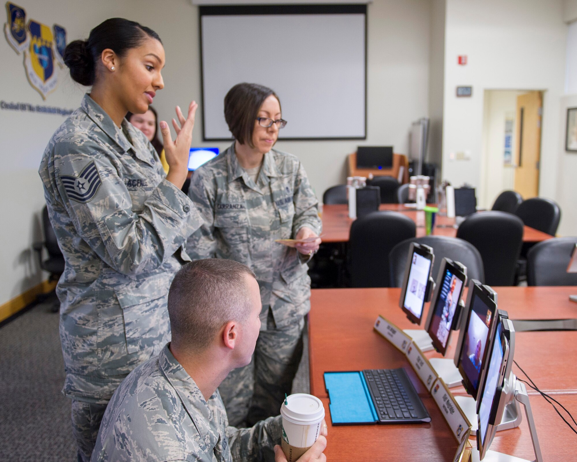 Tech. Sgt. Tamara Acfalle, 45th Force Support Squadron Airman Leadership School instructor, left, speaks with the students of the first virtual classroom, at the PAFB Professional Development Center. Master Sgt. Monica Carranza, 45th Medical Group Public Health professional, back, and Tech. Sgt. Brent Kenney, also a PAFB ALS instructor, front, observe and check for issues. (U.S. Air Force photo/Matthew Jurgens) (Released)
