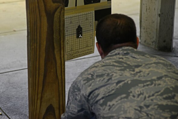 Master Sgt. Edward Musterer, 22nd Maintenance Group quality assurance chief inspector, checks his target after firing an M4 carbine during a rifle shooting competition, May 12, 2015, at McConnell Air Force Base, Kan. The competition was hosted by the 22nd SFS to recognize National Police Week and highlight the importance of law enforcement in the community and helped build camaraderie. (U.S. Air Force photo by Airman 1st Class Christopher Thornbury)