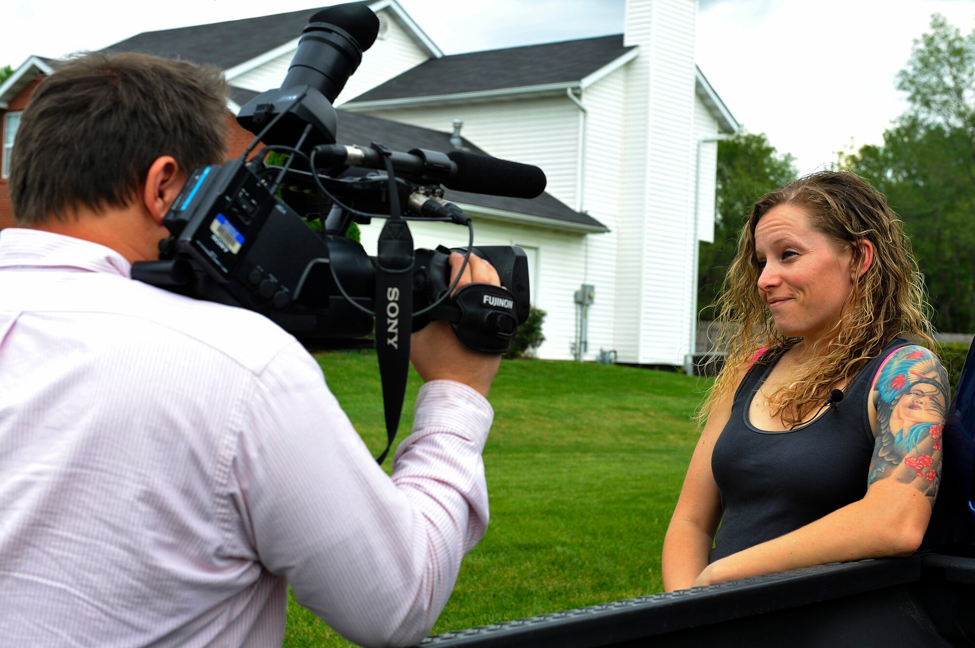 Staff Sgt. Arin Vickers, 435 Supply Chain Operations Squadron, is interviewed by Steve Harris, St. Louis Channel 4 KMOV Reporter, May 6, 2015. Vickers was gone on a deployment for 6 months and rescued a puppy named Bandit  who she was able to adopt and waited until her deployment was up to be reunited. (U.S. Air Force photo by Airman 1st Class Erica Crossen)