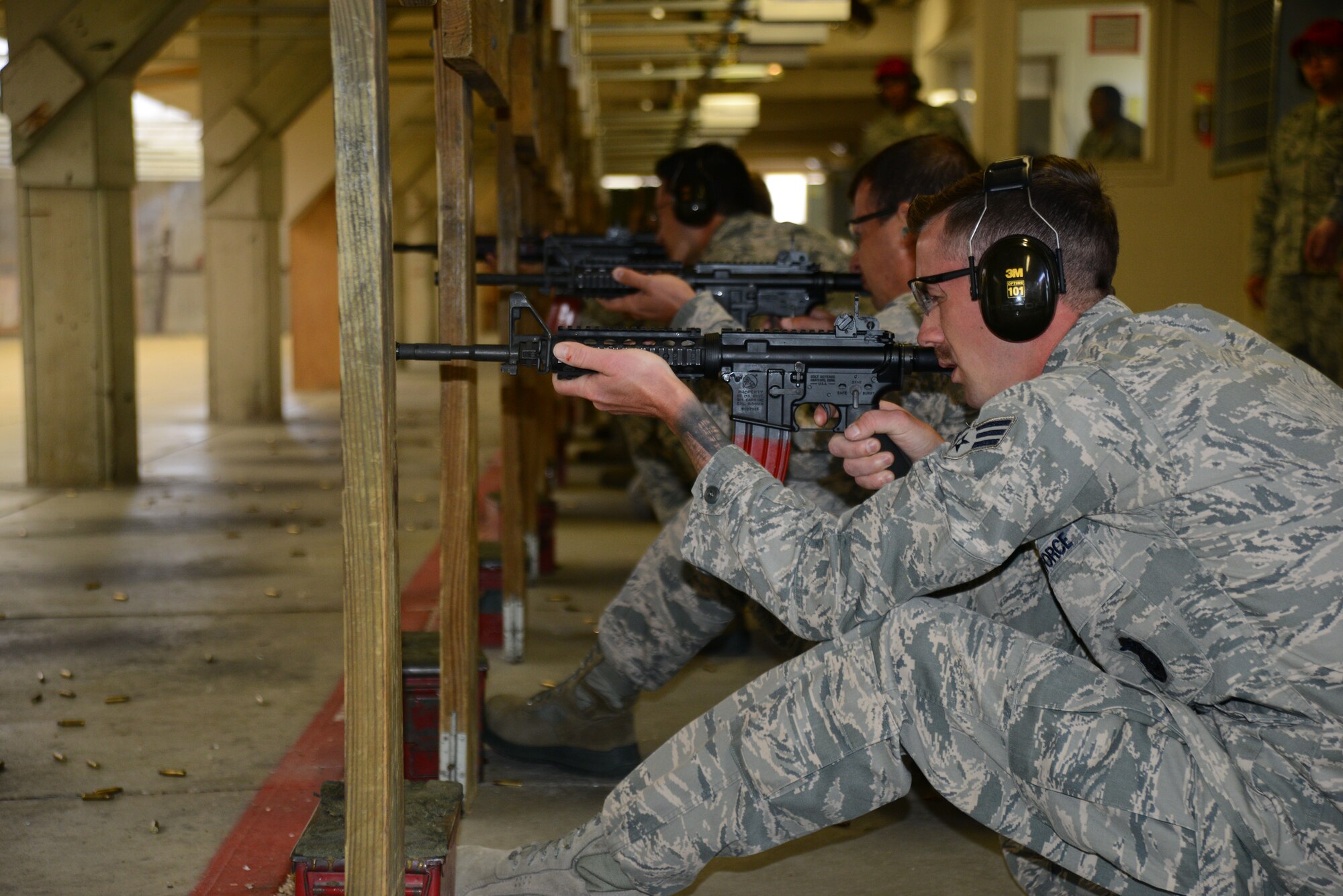 Senior Airman Lance Poteet, 22nd Security Forces Squadron patrolman, fires an M4 carbine during a rifle shooting competition, May 12, 2015, at McConnell Air Force Base, Kan. The competition was hosted by the 22nd SFS to recognize National Police Week and highlight the importance of law enforcement in the community and helped build camaraderie. (U.S. Air Force photo by Airman 1st Class Christopher Thornbury)
