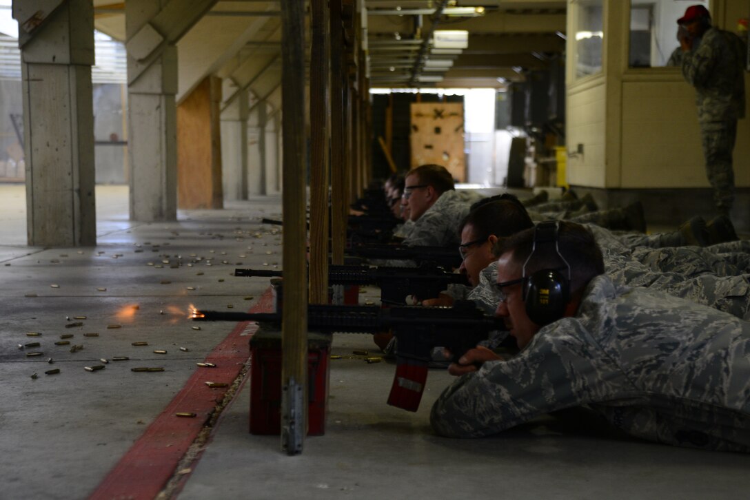 Senior Airman Lance Poteet, 22nd Security Forces Squadron patrolman, fires an M4 carbine during a rifle shooting competition, May 12, 2015, at McConnell Air Force Base, Kan. The competition was hosted by the 22nd SFS to recognize National Police Week and highlight the importance of law enforcement in the community and helped build camaraderie. (U.S. Air Force photo by Airman 1st Class Christopher Thornbury)