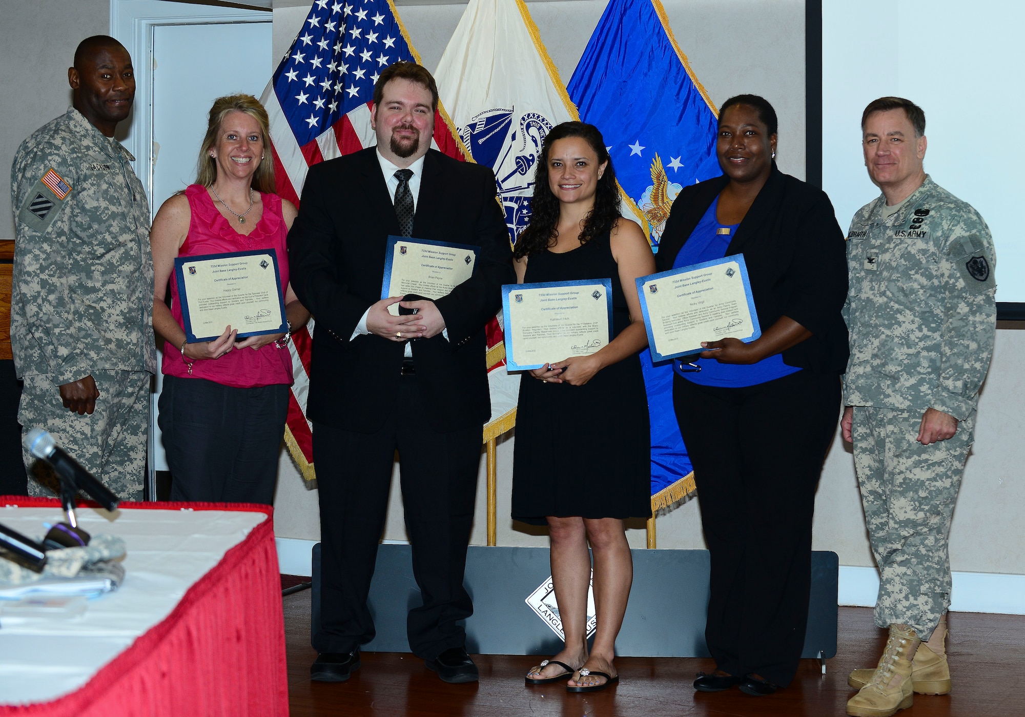 U.S. Army Col. William Galbraith, 733rd Mission Support Group commander, and U.S. Army Sgt. Maj. James Jackson, 733rd MSG command sergeant major, congratulate five volunteers of the quarter at Fort Eustis, Va., May 12, 2015. These members were recognized within their units for volunteer work they conducted on and off base. (U.S. Air Force photo by Senior Airman Kimberly Nagle/Released)