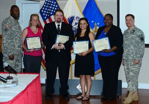 U.S. Army Col. William Galbraith, 733rd Mission Support Group commander, and U.S. Army Sgt. Maj. James Jackson, 733rd MSG command sergeant major, congratulate five volunteers of the quarter at Fort Eustis, Va., May 12, 2015. These members were recognized within their units for volunteer work they conducted on and off base. (U.S. Air Force photo by Senior Airman Kimberly Nagle/Released)
