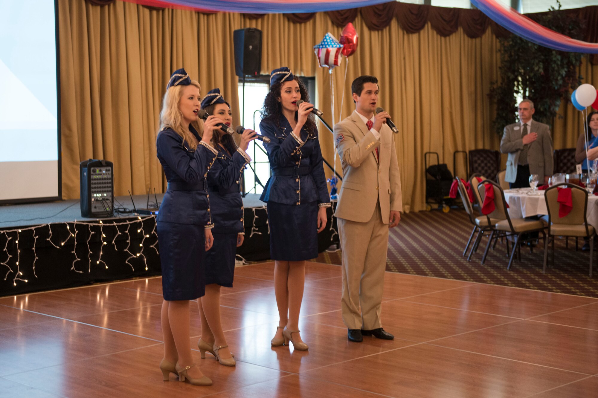 Members of the New York USO Troupe sing the national anthem at the annual Spouses Appreciation Day Luncheon on Joint Base McGuire-Dix-Lakehurst, N.J. May 8, 2015. The luncheon gave an opportunity for services members to express gratitude for sacrifices made by their spouses. (U.S. Air Force photo by Airman 1st Class Joshua King)