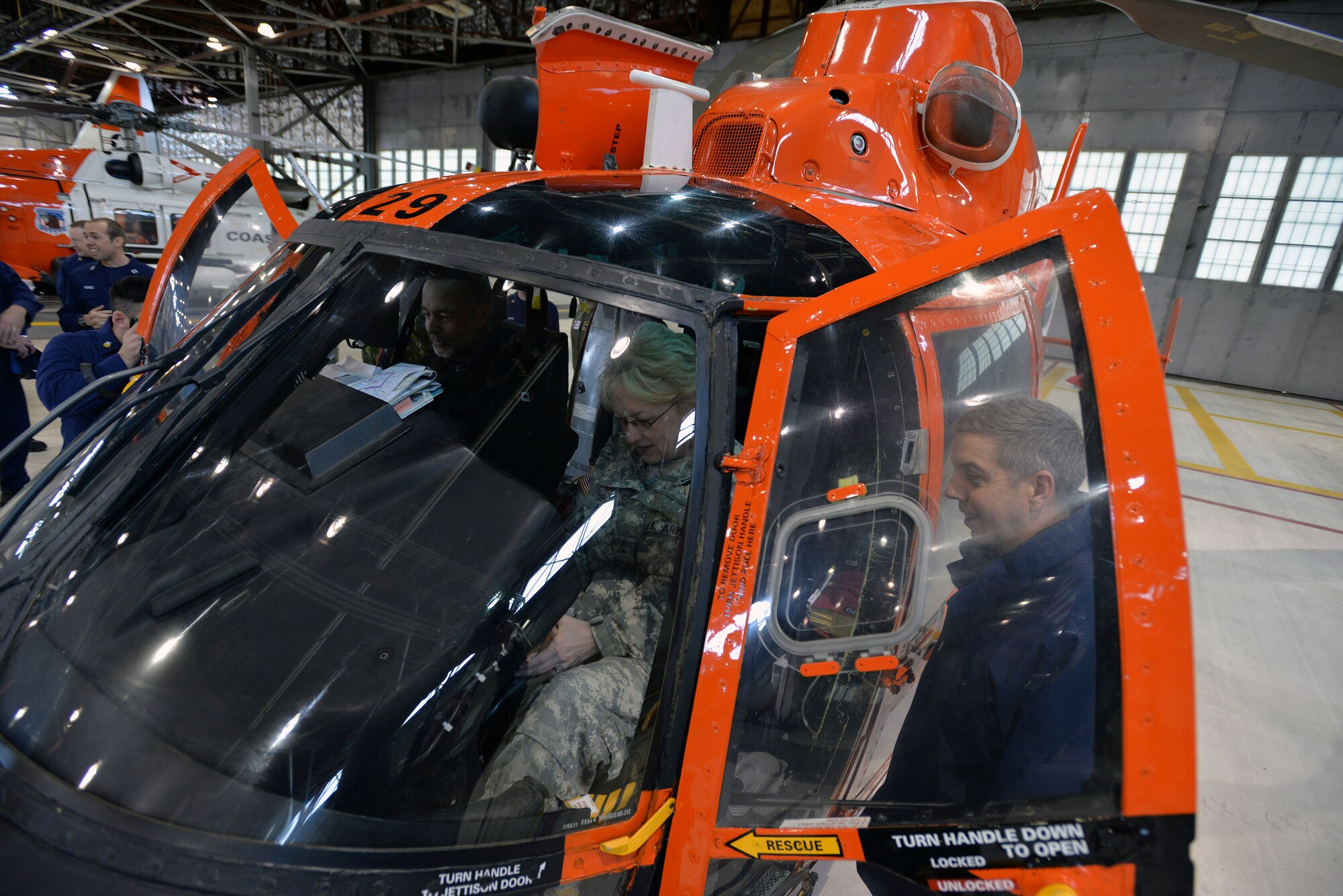 COAST GUARD BASE KODIAK, Alaska — U.S. Coast Guard Rear Admiral Daniel Abel (right), USCG Distric 17 commander, discusses aircraft avionics, sensors and capabilities with Brig. Gen. Laurel Hummel (Alaska, middle), the adjutant general, and  Royal Canadian Navy Rear Admiral William S. Truelove (left), commander Joint Task Force-Pacific, during an Arctic General Officer/Flag Officer Conference April 30. Alaskan Command and U.S. Coast Guard’s District 17 hosted the Arctic GO/FO Conference April 29 – May 1, which included flag officers from the U.S. Air Force, U.S. Army, U.S. Coast Guard, Alaska National Guard and Canadian Forces, to strengthen partnerships, discuss future Arctic and Alaskan challenges and joint capabilities. (U.S. Air Force photo/Tech. Sgt. John Gordinier)