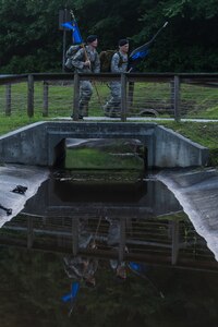Airman 1st Class Hunter Dudley and Lt. Col. Warren Brainard, 628th Security Forces Squadron commander, cross a bridge with the squadron guidon and the “Thin Blue Line” flag May 12, 2015 at Joint Base Charleston, S.C., during a 24-hour ruck march. The event to honor police officers killed in the line of duty was held as part of the 2015 National Police Week celebration. The ‘Thin Blue Line’ represents the sacrifices made by those who protect and serve. Events for this year’s police week include a picnic, a 24-hour ruck march, a golf tournament, a chili cook-off, motorcycle ride and a retreat ceremony.  (U.S. Air Force photo/Senior Airman Jared Trimarchi) 

