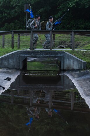 Airman 1st Class Hunter Dudley and Lt. Col. Warren Brainard, 628th Security Forces Squadron commander, cross a bridge with the squadron guidon and the “Thin Blue Line” flag May 12, 2015 at Joint Base Charleston, S.C., during a 24-hour ruck march. The event to honor police officers killed in the line of duty was held as part of the 2015 National Police Week celebration. The ‘Thin Blue Line’ represents the sacrifices made by those who protect and serve. Events for this year’s police week include a picnic, a 24-hour ruck march, a golf tournament, a chili cook-off, motorcycle ride and a retreat ceremony.  (U.S. Air Force photo/Senior Airman Jared Trimarchi) 

