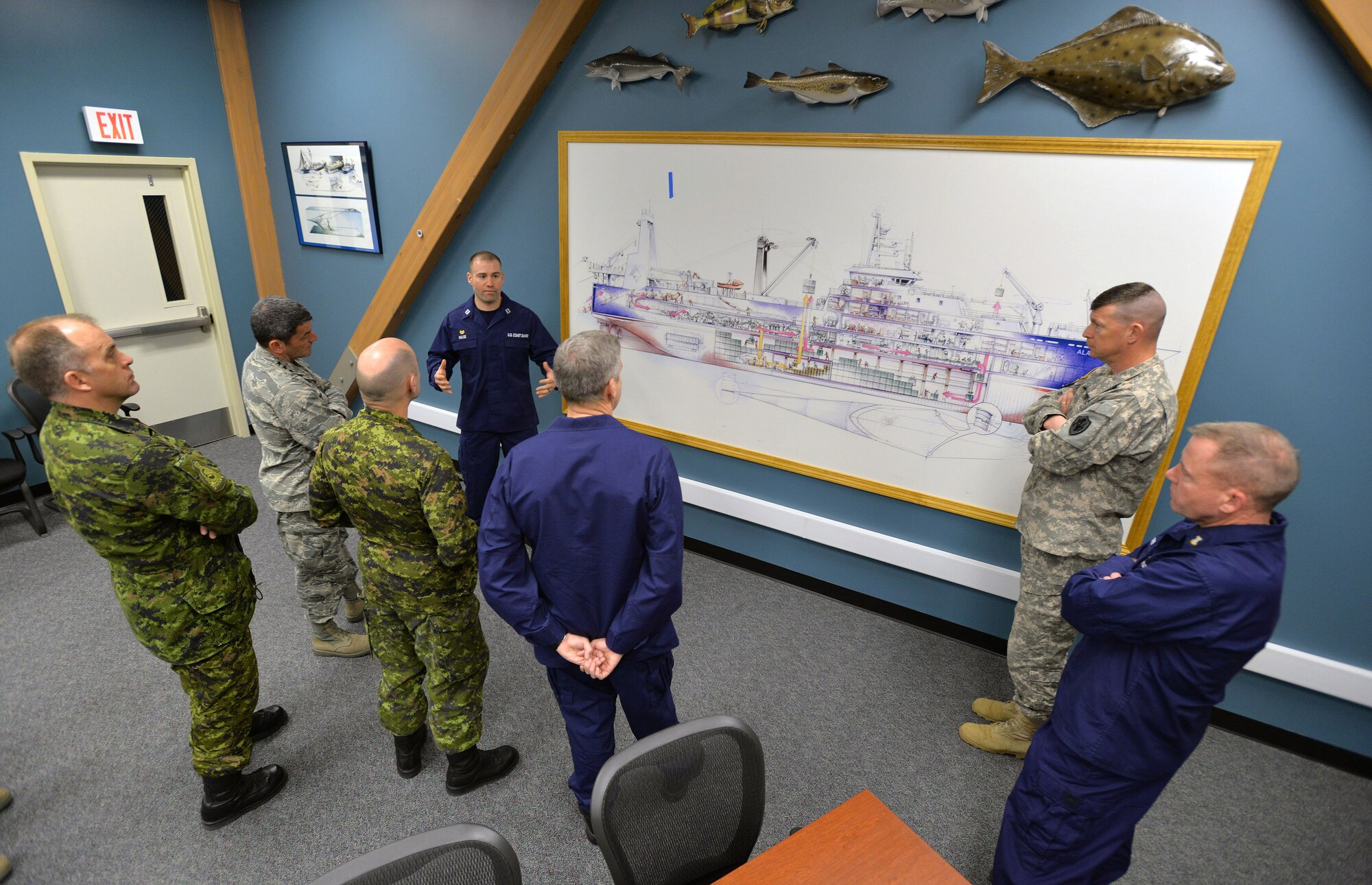 COAST GUARD BASE KODIAK, Alaska — U.S. Coast Guard Lt. Steven Hulse (upper left), North Pacific Regional Fisheries Training Center commanding officer, explains local Alaskan fishery operations and training center curriculum to attendees of the General Officer/Flag Officer conference April 30. Alaskan Command and U.S. Coast Guard’s District 17 hosted the Arctic GO/FO Conference April 29 – May 1, which included flag officers from the U.S. Air Force, U.S. Army, U.S. Coast Guard, Alaska National Guard and Canadian Forces, to strengthen partnerships, discuss future Arctic and Alaskan challenges and joint capabilities. (U.S. Air Force photo/Tech. Sgt. John Gordinier)

 
