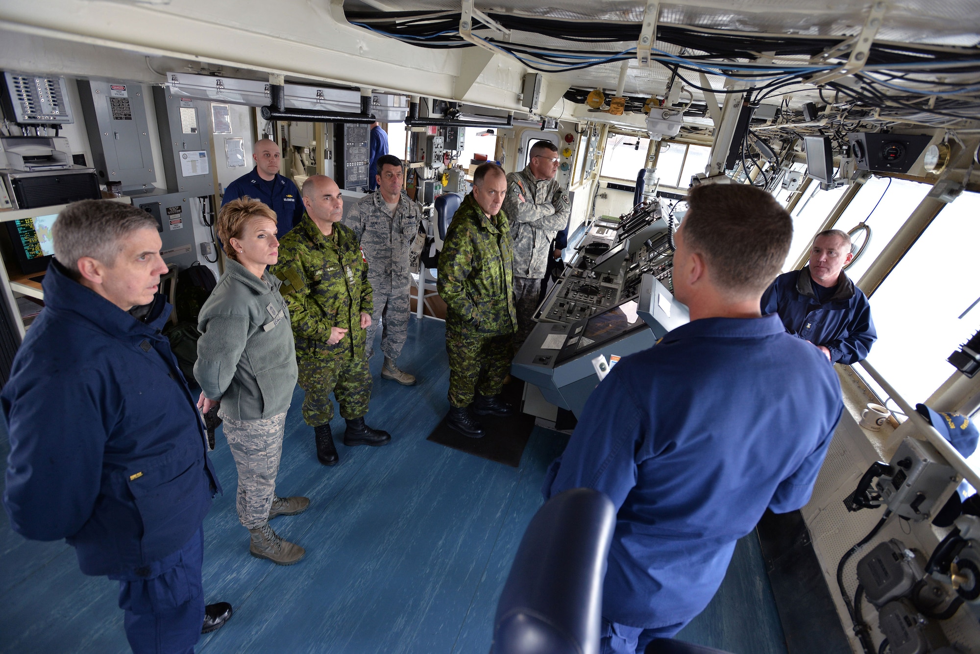 COAST GUARD BASE KODIAK, Alaska — U.S. Coast Guard Lt. Commander Douglas Jannusch (lower right), USCG Buoy Tender SPAR commanding officer, explains the missions and capabilities of the Coast Guard maritime vessel to attendees of the General Officer/Flag Officer conference April 30. Alaskan Command and U.S. Coast Guard’s District 17 hosted the Arctic GO/FO Conference April 29 – May 1, which included flag officers from the U.S. Air Force, U.S. Army, U.S. Coast Guard, Alaska National Guard and Canadian Forces, to strengthen partnerships, discuss future Arctic and Alaskan challenges and joint capabilities. (U.S. Air Force photo/Tech. Sgt. John Gordinier)