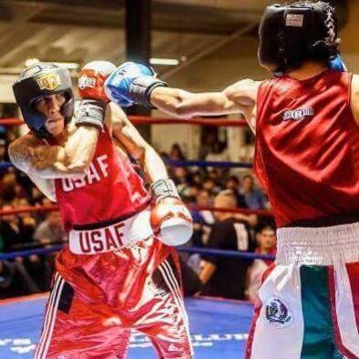 Senior Airman Kenneth De Jesus-Cruz, 9th Aircraft Maintenance Squadron cyber transport technician, dodges a punch thrown from Angel Garcia of Advocates Boxing during the Golden Glove tournament in San Antonio, Feb. 19, 2013. Cruz won this fight in a 3-2 decision. (Courtesy photo)