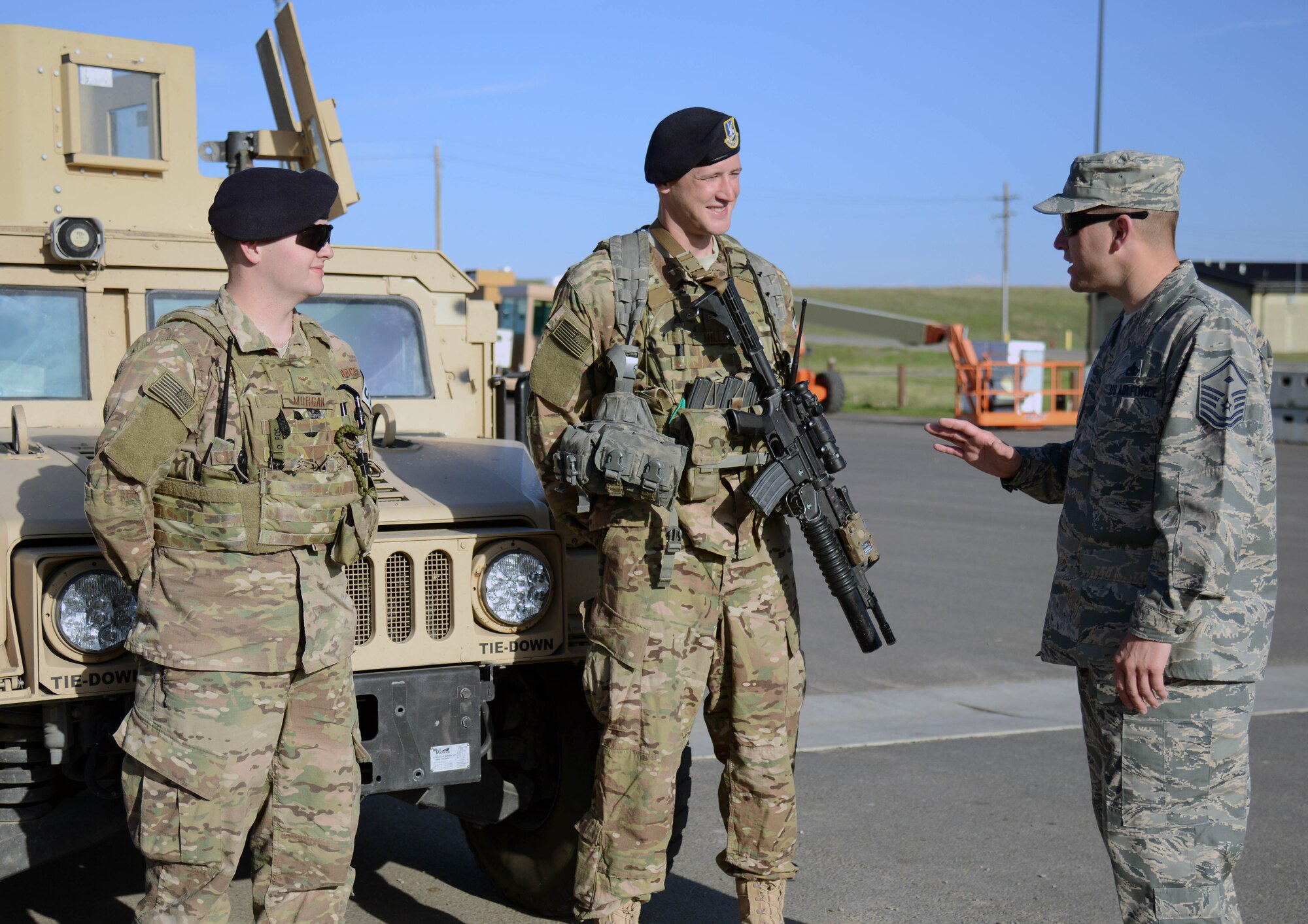 Master Sgt. Jason Whitehead, right, 341st Security Forces Squadron first sergeant, speaks with Airmen 1st Class Richard Morgan, left, and Ricky Miller during a post visit May 5, 2015, at Malmstrom Air Force Base, Mont. Whitehead periodically checks in with Airmen to see how their personal lives are going in order to keep a finger on the pulse of the squadron. (U.S. Air Force photo/ Airman 1st Class Dillon Johnston)