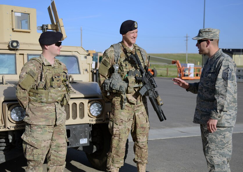 Master Sgt. Jason Whitehead, right, 341st Security Forces Squadron first sergeant, speaks with Airmen 1st Class Richard Morgan, left, and Ricky Miller during a post visit May 5, 2015, at Malmstrom Air Force Base, Mont. Whitehead periodically checks in with Airmen to see how their personal lives are going in order to keep a finger on the pulse of the squadron. (U.S. Air Force photo/ Airman 1st Class Dillon Johnston)