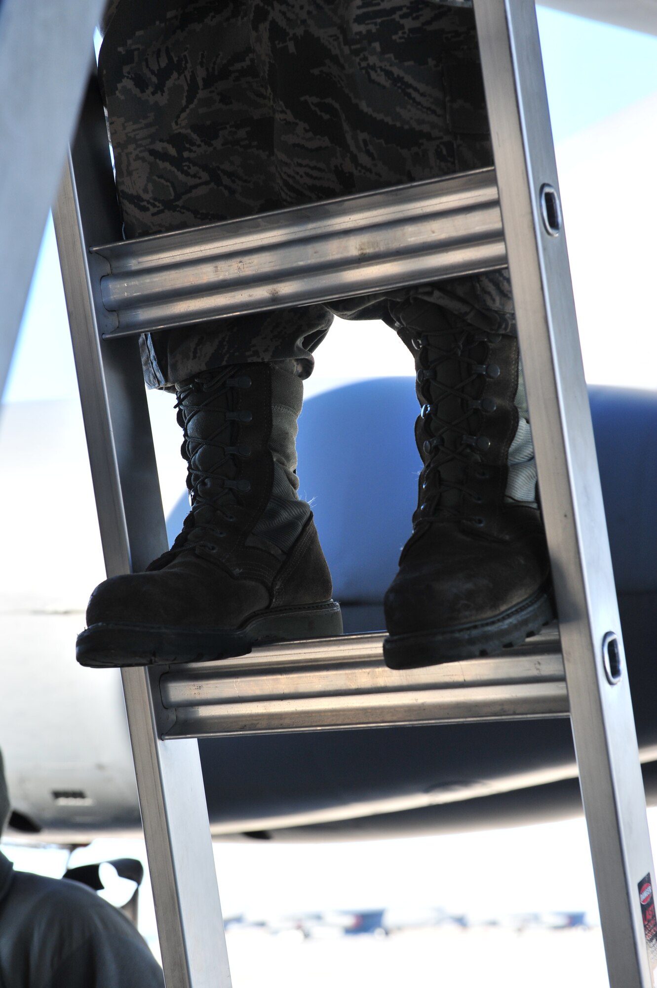 Senior Airman Kasey Castor, 5th Maintenance Group weapons load crew team member, climbs a ladder on Minot Air Force Base, N.D., Jan. 30, 2015. Castor performed maintenance on a section of the B-52H Stratofortress with her team members. (U.S. Air Force photo/Senior Airman Malia Jenkins)