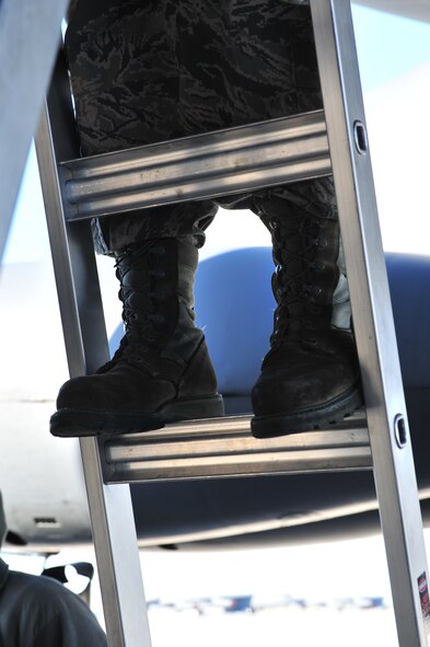 Senior Airman Kasey Castor, 5th Maintenance Group weapons load crew team member, climbs a ladder on Minot Air Force Base, N.D., Jan. 30, 2015. Castor performed maintenance on a section of the B-52H Stratofortress with her team members. (U.S. Air Force photo/Senior Airman Malia Jenkins)