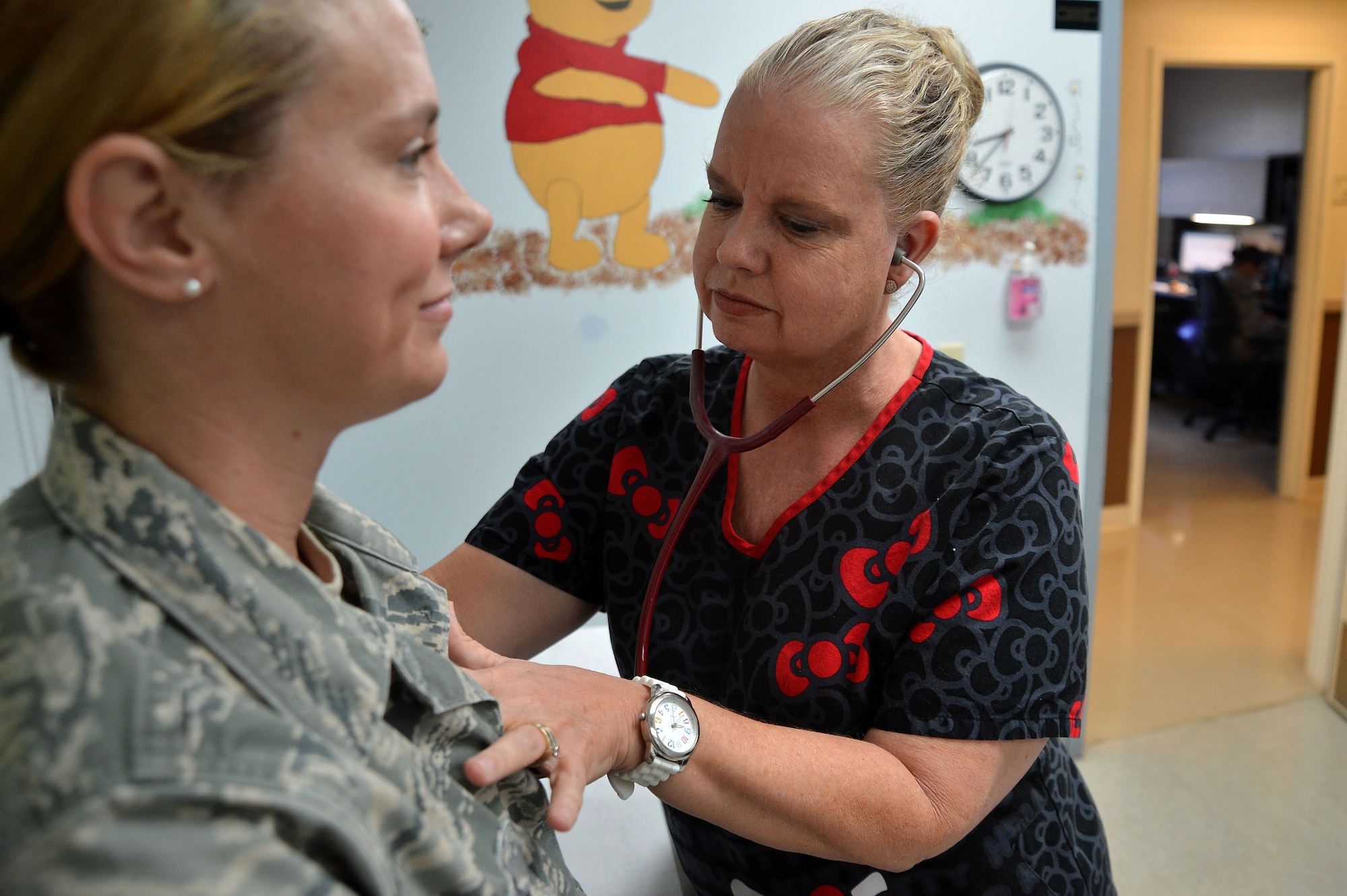 Debra Green, 20th Medical Operations Squadron pediatrics nurse, checks the heartbeat of Staff Sgt. Amanda Payne, 20th MDOS medical technician, at Shaw Air Force Base, S.C., May 12, 2015. Throughout the Air Force, May 6-12, nurses and medical technicians were recognized for the care they provide to service members and their families. (U.S. Air Force photo by Airman 1st Class Michael Cossaboom/Released)