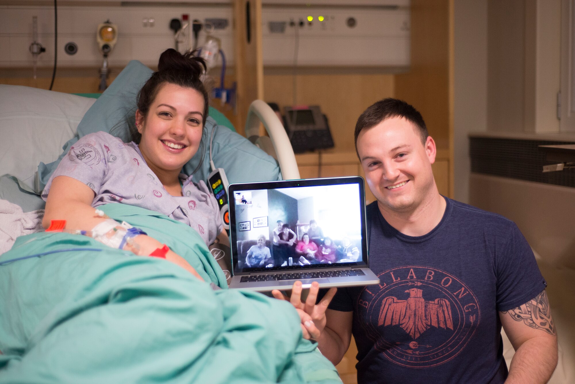 Staff Sgt. Bobby Cash, 351st Air Refueling Squadron boom operator, and his wife Tabetha, pose for a photo with their family via Skype at Royal Air Force Lakenheath, England, May 7, 2015. Newly-installed base Wi-Fi allowed family members to communicate around the world during a priceless moment. (U.S. Air Force photo by Carly Moon-Warnick)