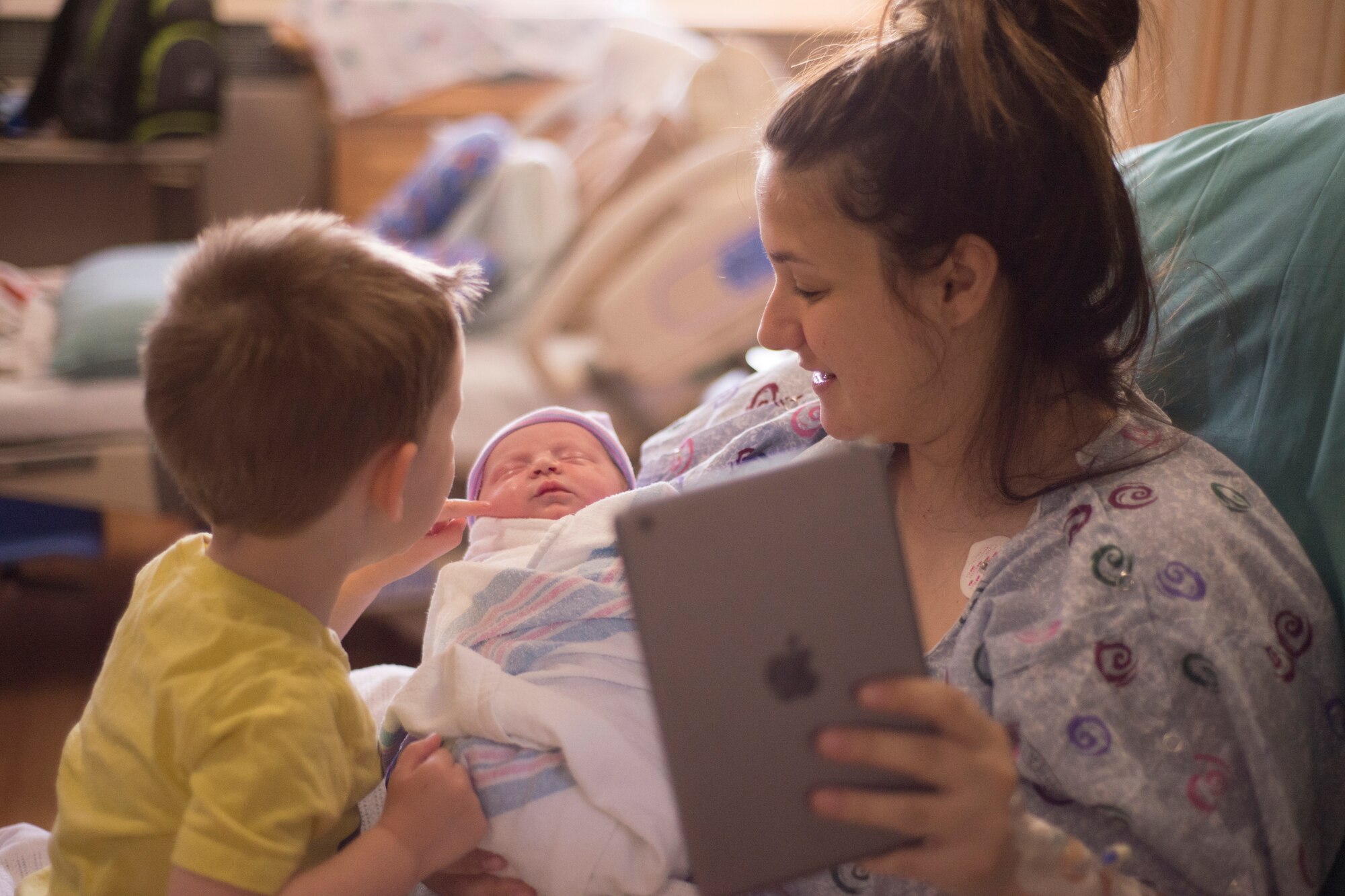 Using a tablet and newly-installed Wi-Fi, Alyssa Pfeifer shows her new son to husband, Airman 1st Class Bryan Pfeifer, for the first time via FaceTime at Royal Air Force Lakenheath, England, April 23, 2015. “It was such a relief to know that Bryan could share the moment live via FaceTime,” she said. “His face lit up like I had never seen before.” A1C Pfeifer works in the 48th Civil Engineer Squadron as a heavy equipment operator. (U.S. Air Force photo by Carly Moon-Warnick)