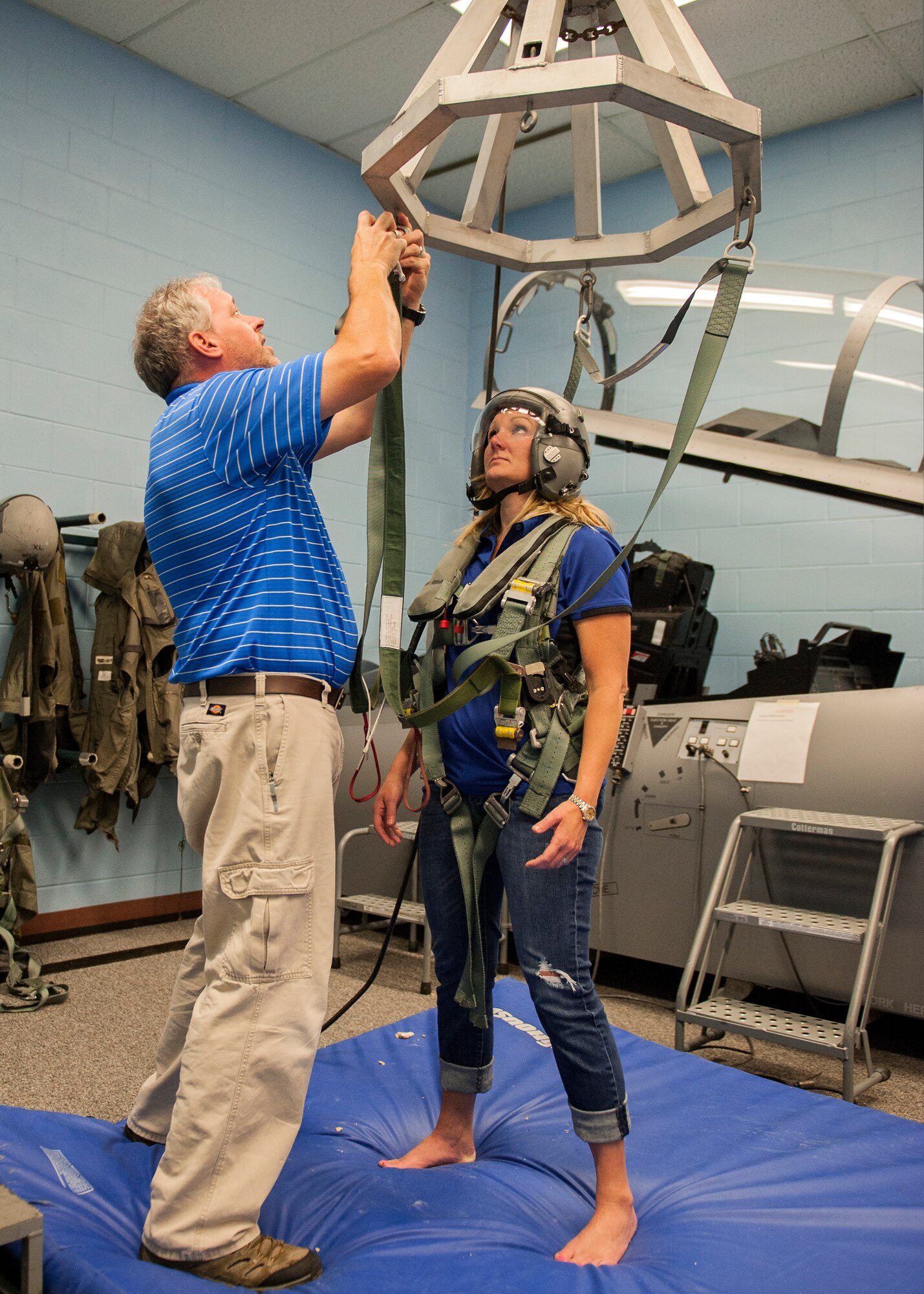 Whitney Smith, a Shalimar attorney and 53rd Wing honorary commander, looks on as William Talton, a 96th Operations Support Squadron aviation flight equipment instructor, performs a safety check of the hanging harness during emergency parachute training May 6 at Eglin Air Force Base, Fla.  The EPT was required to prepare Smith for an incentive flight in an F-15E Strike Eagle.  This was the first incentive flight awarded to an honorary commander in more than three years.  The 53rd Wing’s honorary commander program allows local community leaders the unique opportunity to interact with and learn about the 53rd Wing Airmen, their mission and the role they play in supporting the Air Force.  (U.S. Air Force Photo/Ilka Cole)