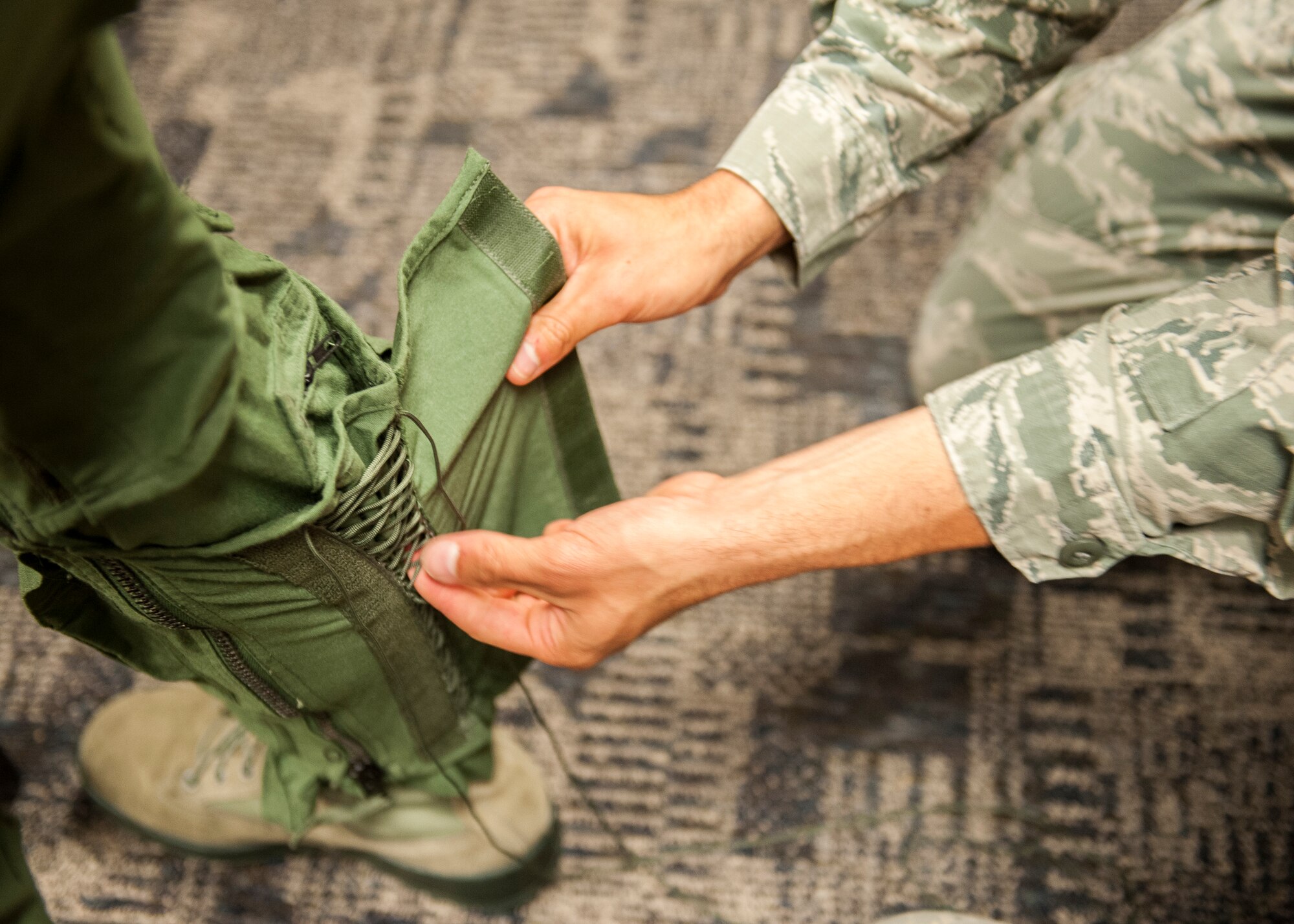 An air flight equipment technician with the 85th Test and Evaluation Squadron, laces the anti-G suit of Whitney Smith, a Shalimar attorney and 53rd Wing honorary commander, during an aircraft flight equipment fitting May 6 at Eglin Air Force Base, Fla.  The AFE fitting was required to prepare Smith for G forces during her incentive flight in an F-15E Strike Eagle.  This was the first incentive flight awarded to an honorary commander in more than three years.  The 53rd Wing’s honorary commander program allows local community leaders the unique opportunity to interact with and learn about the 53rd Wing Airmen, their mission and the role they play in supporting the Air Force. (U.S. Air Force Photo/Ilka Cole)