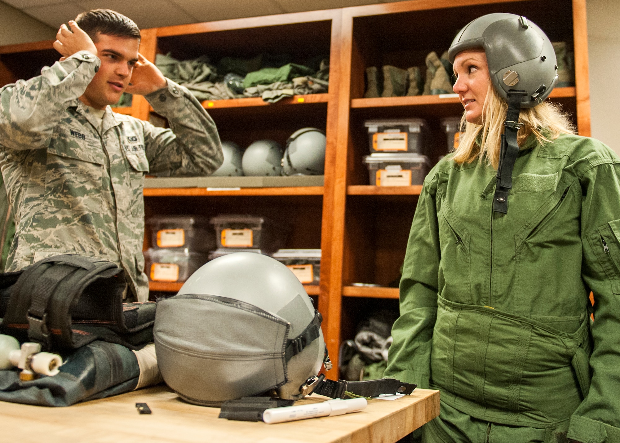 Whitney Smith, a Shalimar attorney and 53rd Wing honorary commander looks on as Senior Airman, Benjamin Webb, of the 85th Test and Evaluation Squadron, instructs her on proper helmet and oxygen mask fit during an aircraft flight equipment fitting May 6 at Eglin Air Force Base, Fla.  The AFE fitting was required to prepare Smith for an incentive flight in an F-15E Strike Eagle.  This was the first incentive flight awarded to an honorary commander in more than three years.  The 53rd Wing’s honorary commander program allows local community leaders the unique opportunity to interact with and learn about the 53rd Wing Airmen, their mission and the role they play in supporting the Air Force.  (U.S. Air Force Photo/Ilka Cole)