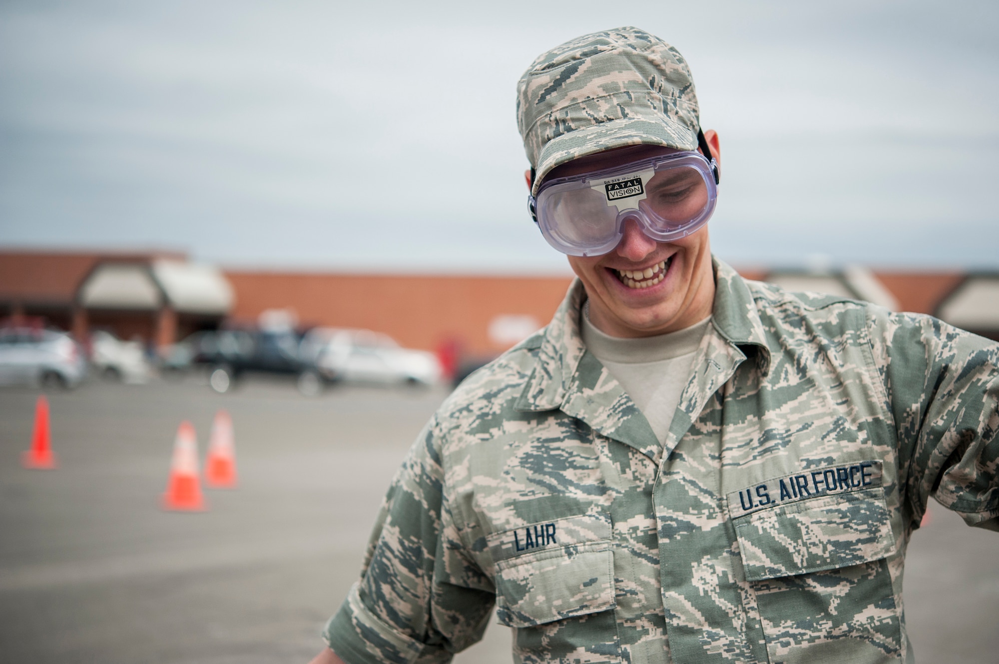 U.S. Air Force Airman Jacob A. Lahr, 315th Training Squadron student, tries to balance while wearing impairment goggles at the Drunk Driver Course in front of the commissary on Goodfellow Air Force Base, Texas, May 11, 2015. The goggles allow participants to experience a field sobriety test as if they were under the influence. (U.S. Air Force photo by Senior Airman Michael Smith/Released)