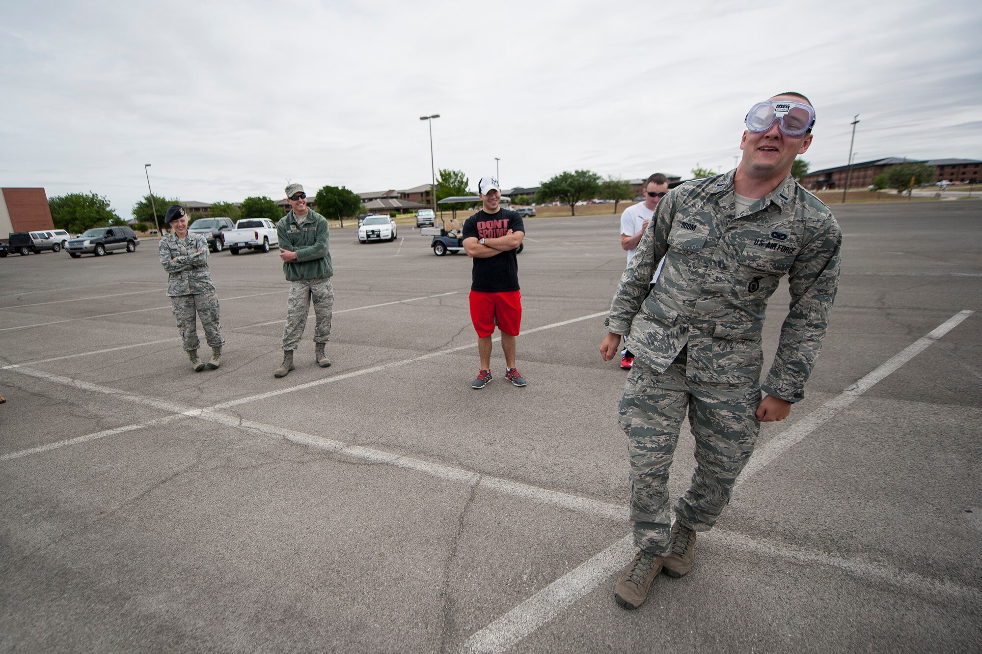 U.S. Air Force 1st Lt. Richard K. Odom, 17th Security Forces Squadron operations officer, tries walking in a straight line while wearing impairment goggles at the Drunk Driver Course in front of the commissary on Goodfellow Air Force Base, Texas, May 11, 2015. The goggles allow participants to experience a field sobriety test as if they were under the influence. (U.S. Air Force photo by Senior Airman Michael Smith/Released)
