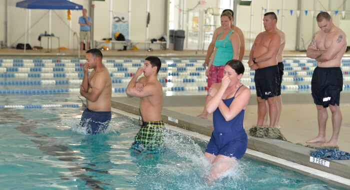 Members of Navy Reserve Navy Security Force Joint Base Charleston – Weapons Station take the plunge beginning the swimmer’s qualification test. The reservists were participating in a week-long training regimen beginning May 4, 2015 to ensure all members of the NRNSF unit are mission ready to support their active duty counterparts throughout Joint Base Charleston. (U.S. Air Force photo / Seamus O'Boyle)