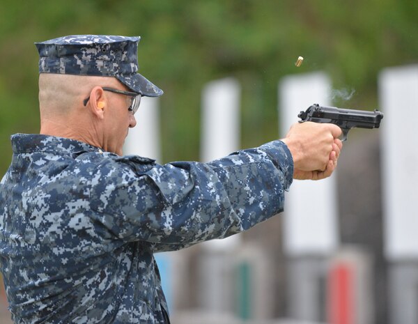 Master at Arms Chief, Scott Perry, the senior enlisted member of NRNSF Joint Base Charleston – Weapons Station, fires his weapon on the firing range as part of small arms training. The reservists were participating in a week-long training regimen beginning May 4, 2015 to ensure all members of the NRNSF unit are mission ready to support their active duty counterparts throughout Joint Base Charleston. (U.S. Air Force photo / Seamus O'Boyle)