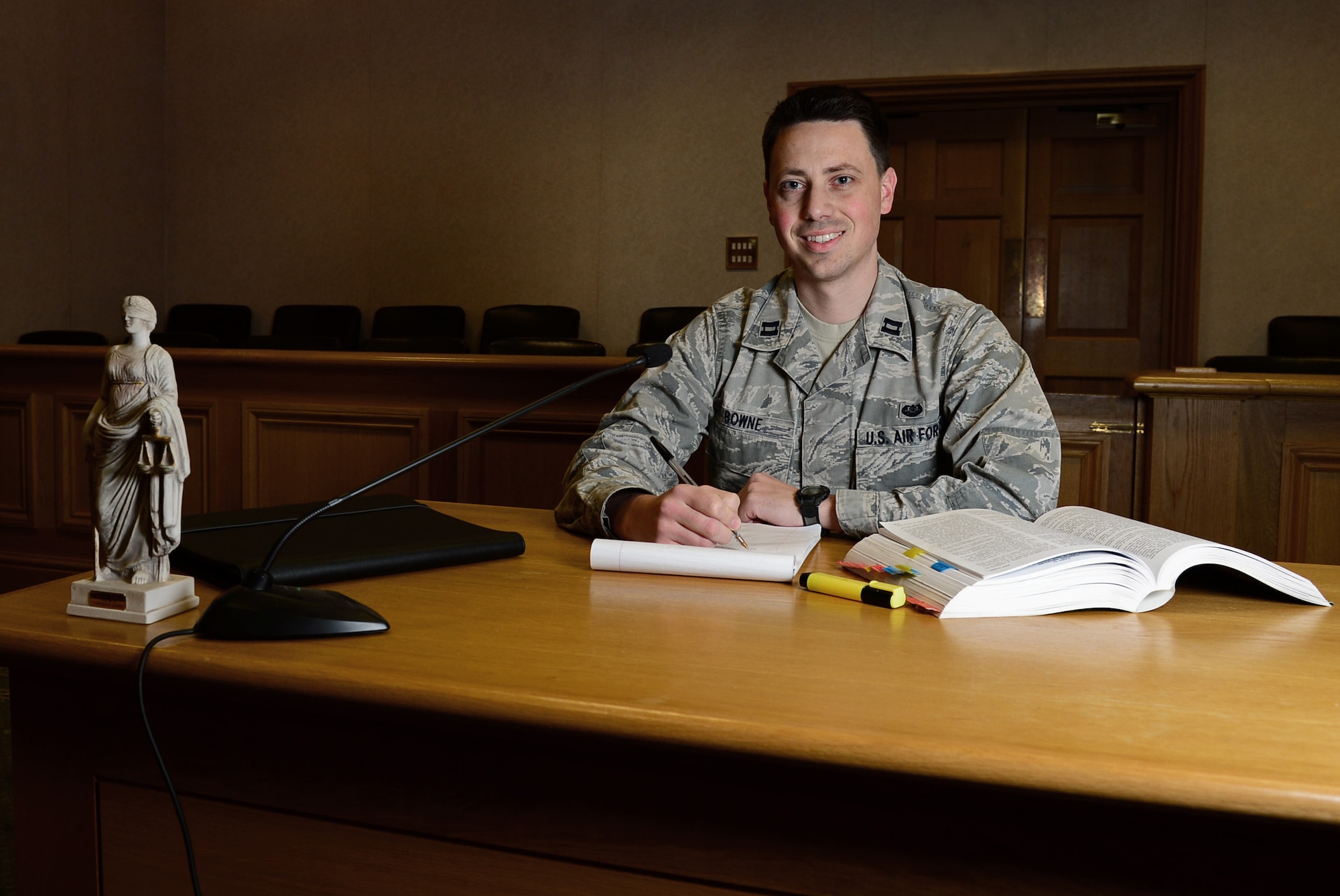 Capt. Andrew Bowne, 48th Fighter Wing Office of the Staff Judge Advocate chief of military justice, sits in the courtroom at Royal Air Force Lakenheath, England, May 7, 2015. Bowne was nominated for a Liberty Spotlight because he embodies the core values of Service Before Self and Excellence In All We Do. (U.S. Air Force photo by Airman 1st Class Erin R. Babis/Released)